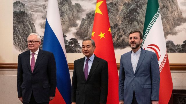 Chinese Foreign Minister Wag Yi, stands with Russian Deputy Foreign Minister Sergey Ryabkov, left, and Iranian Deputy Foreign Minister Kazeem Gharibabadi, right, before a meeting regarding the Iranian nuclear issue at Diaoyutai State Guest House on March 14, 2025 in Beijing, China. (Pool Photo via AP)


