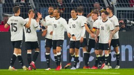 Germany's Jamal Musiala, centre, celebrates with teammates after scoring his side's second goal during the Nations League quarterfinal second leg soccer match between Germany and Italy at the Signal-Iduna Park in Dortmund, Germany, Sunday, March 23, 2025. (AP Photo)