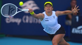 Iga Swiatek hits a return to Caroline Garcia during the Miami Open tennis tournament. (AP Photo)
