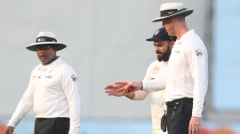 Virat Kohli of India with Michael Gough, Nitin Menon (L). (Sportzpics for IPL)