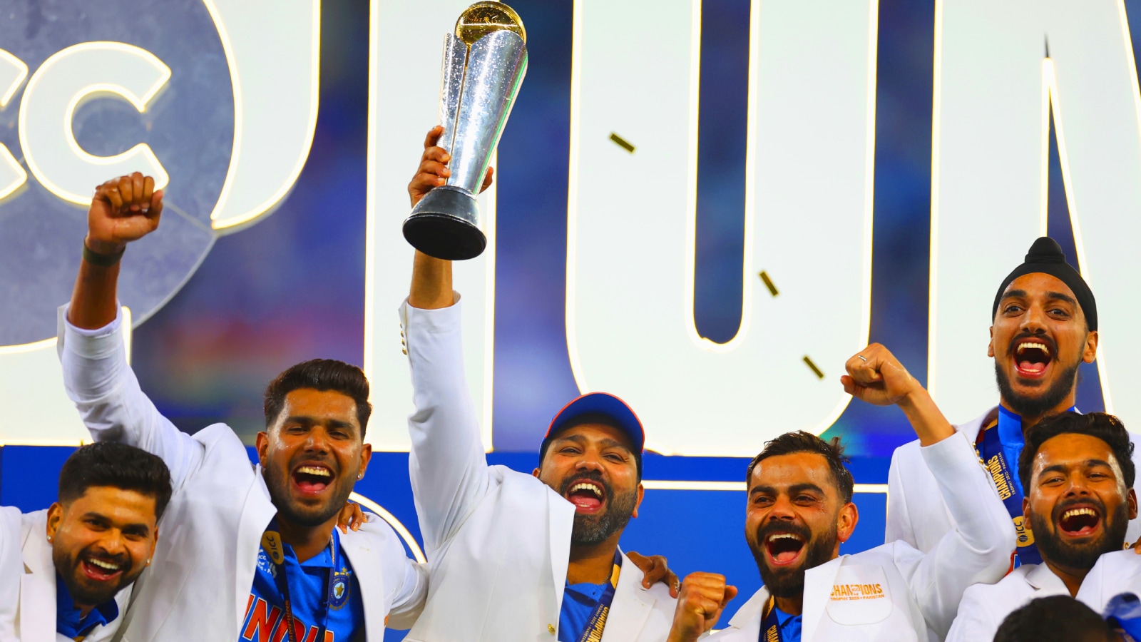 India captain Rohit Sharma and teammates celebrate with the winners trophy on the podium after defeating New Zealand in the final cricket match of the ICC Champions Trophy at Dubai International Cricket Stadium in Dubai, United Arab Emirates, Sunday, March 9, 2025. (AP Photo)