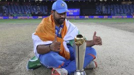 India's captain Rohit Sharma poses with the winners trophy after defeating New Zealand in the final cricket match of the ICC Champions Trophy at Dubai International Cricket Stadium in Dubai, United Arab Emirates. (AP)