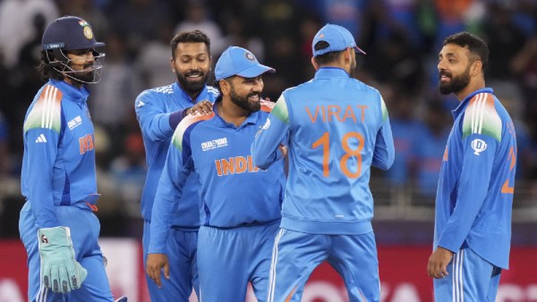 India's Varun Chakaravarthy with teammates celebrates the wicket of New Zealand's Mitchell Santner during the ICC Champions Trophy cricket match between India and New Zealand, in Dubai, UAE. (PTI)