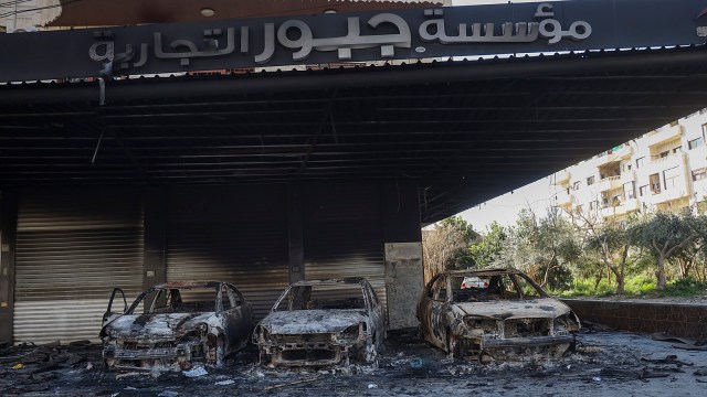 Burnt cars remain in an open garage following the recent wave of violence between Syrian security forces and gunmen loyal to former President Bashar Assad, in the town of Jableh, Syria's coastal region, on Monday