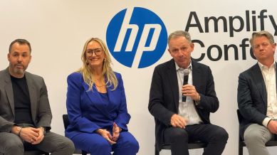 HP Inc. CEO Enrique Lores (center) is seen addressing the media at the Amplify Conference 2025 in Nashville, Tennessee.