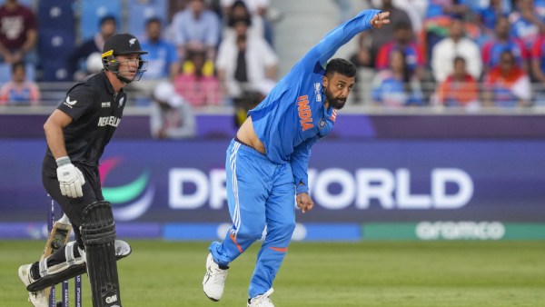 India's Varun Chakravarthy bowls a delivery during the ICC Champions Trophy cricket match between India and New Zealand, in Dubai, UAE. (AP)