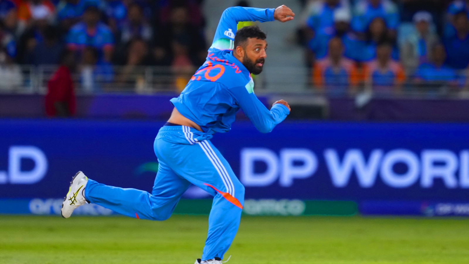 India's Varun Chakravarty bowls a deliver during the ICC champions trophy Cricket Match India and New Zealand at Dubai International Cricket Stadium in Dubai, United Arab Emira, Sunday, March 2, 2055. Photo)