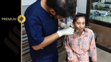 Doctor adjusts Priyanka's jaw extender supports