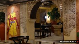 The Husain Room features three large paintings by MF Husain — an Urdu calligraphy surrounded with bold colours, a painting of a begum holding a chilam, and a self-portrait in royal attire. (Express Photo by Amit Chakravarty) Mumbai