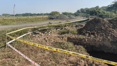 Tragedy site with Lothal Harappan civilization boundary wall in background.