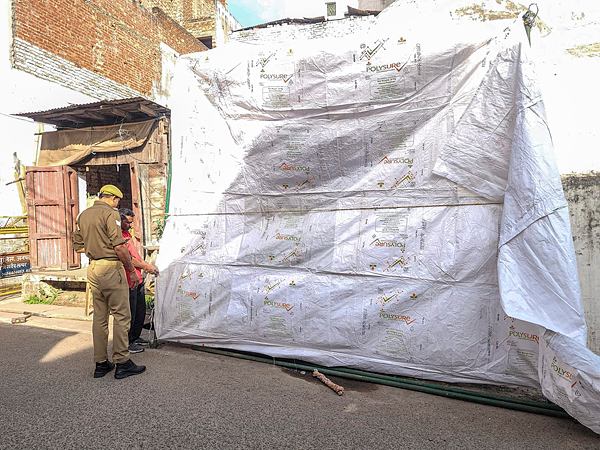 The Shahi Jama Masjid being covered in tarpaulin as prevention against possible holi colour ahead