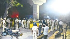 Nagpur Violence: Security personnel disperse an agitating crowd as communal tension prevailed Chitnis park area following the VHP-Bajrang Dal protest in Nagpur. Express photo by Dhananjay Khedkar