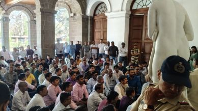 SPPU Admin workers protesting at the main building during the Senate meeting. (Express photo by Soham Shah)