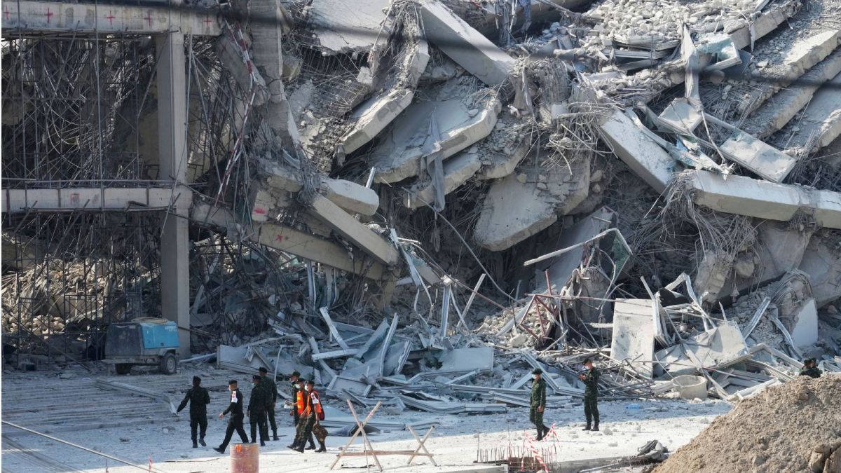 Rescuers walk at the site of a high-rise building under construction that collapsed after a 7.7 magnitude earthquake in Bangkok, Thailand, Friday, March 28, 2025. (AP Photo/Sakchai Lalit)