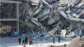 Rescuers walk at the site of a high-rise building under construction that collapsed after a 7.7 magnitude earthquake in Bangkok, Thailand, Friday, March 28, 2025. (AP Photo/Sakchai Lalit)