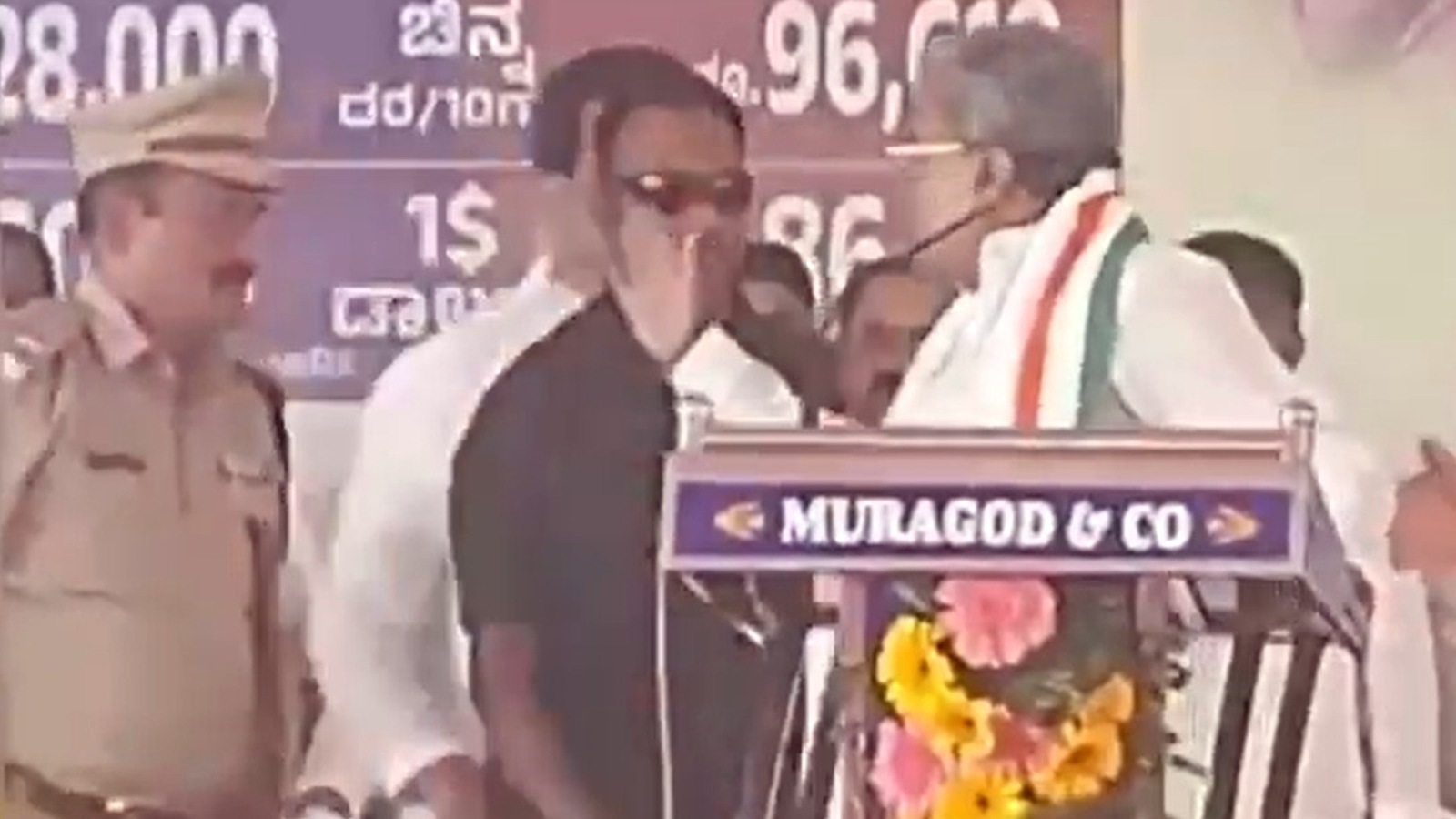 Siddaramaiah gestures with raised hand at cop on dais, draws criticism