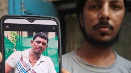 Ariz Shaikh showing photo of his brother (deceased) Rafiq Wazeer Shaikh, the traffic warden who fell off from 50-feet high coastal road bridge while chasing a traffic rule violator.