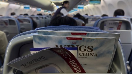 A safety instruction leaflet of an Air China airlines Boeing 737-800 is seen placed together with magazines