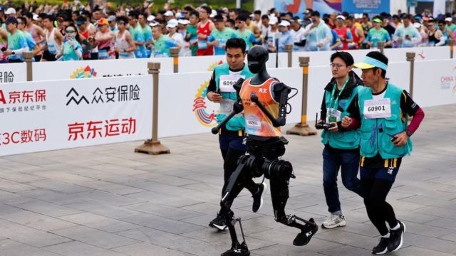 Humanoid robot "Tiangong" participates along with human runners in the E-Town Half Marathon & Humanoid Robot Half Marathon in Beijing, China April, 19 2025. (REUTERS/Tingshu Wang)