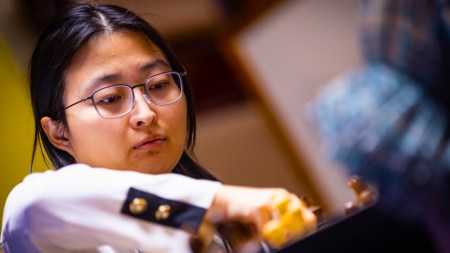 Ju Wenjun makes a move against compatriot Tan Zhongyi in a FIDE Women's World Chess Championship match in China. (PHOTO: Anna Shtourman via FIDE)