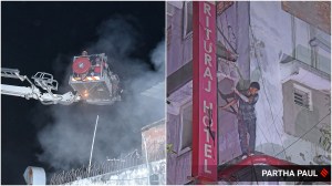 Firefighters douse the flames as people stand on parapets to escape the fire at Rituraj Hotel in Kolkata