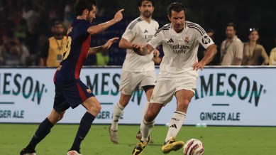 Football legend Luis Figo, playing for Real Madrid Legends, glides past a FC Barcelona Legends player at the DY Patil Stadium in Navi Mumbai. (Express Photo by Amit Chakravarty)