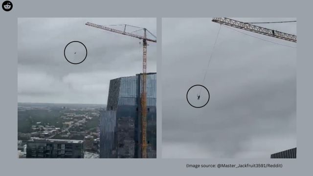 The footage captures a man casually swinging from a construction crane high above downtown Austin