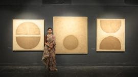 Red Dot recreates the impression of blood stains on the cloth, except that the recurring patterns in the work are made using cow dung and red thread.