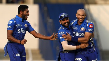 FILE: Tymal Mills (R) with Rohit Sharma and Basil Thampi during IPL 2022. (Sportzpics for IPL)