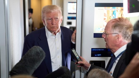 President Donald Trump speaks with reporters on Air Force One on Friday