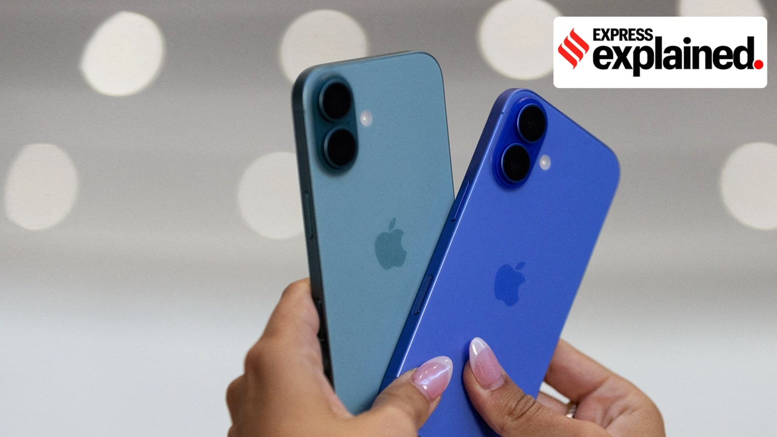 An attendee holds two iPhones 16 as Apple holds an event at the Steve Jobs Theater on its campus in Cupertino, California, U.S. September 9, 2024.