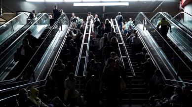 People rest on the stairs at Atocha train station during a power outage