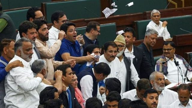MLAs raise slogans inside the House during the Budget session of J&K Assembly, in Jammu, Tuesday, April 8, 2025.