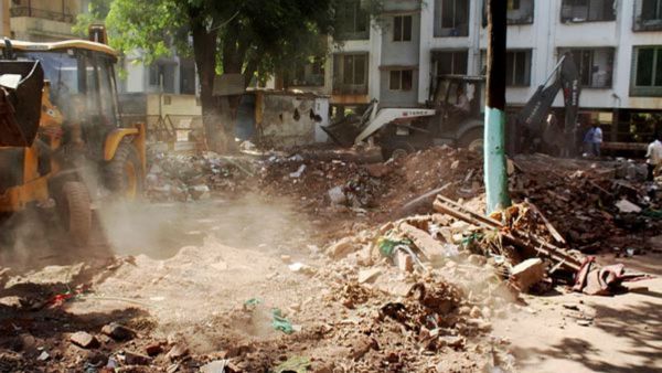 A bulldozer being used to demolish an allegedly illegal structure of a dargah, in Nashik district, Maharashtra. (PTI Photo)