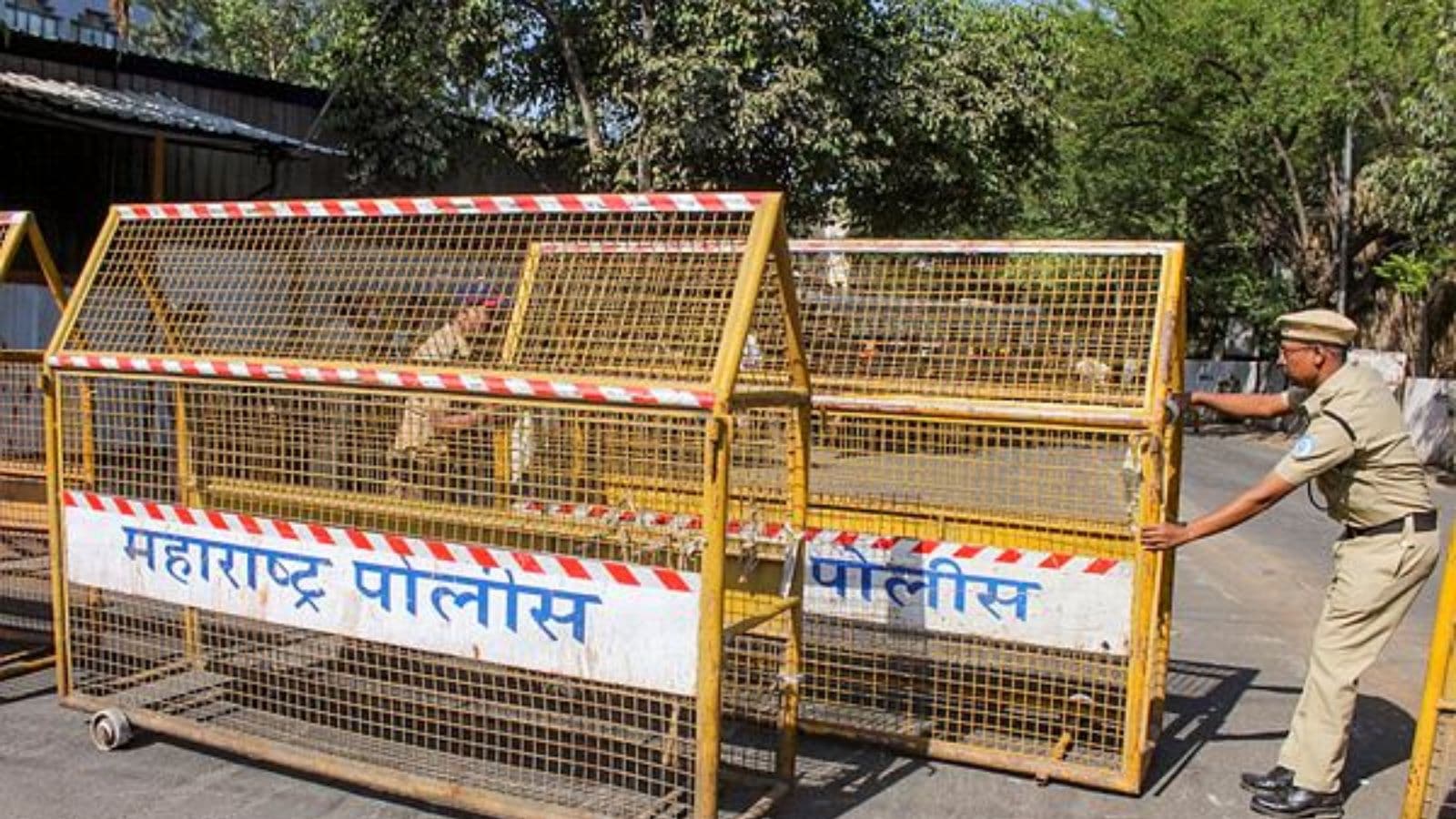 Police personnel put barricades after tension erupted in the area late Tuesday night following attempts by the Municipal Corporation to demolish an allegedly illegal dargah, in Nashik, Maharashtra. (PTI Photo)