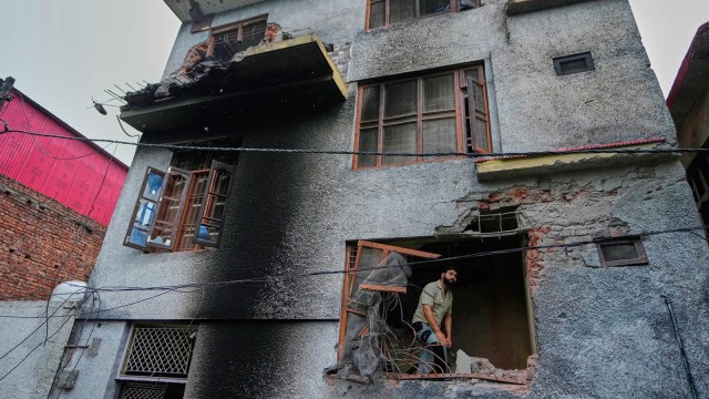 A resident inspects his house damaged by Pakistani artillery shelling in Poonch (AP)