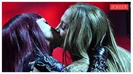 Jennifer Lopez kisses a backup dancer during her opening performance at the American Music Awards.