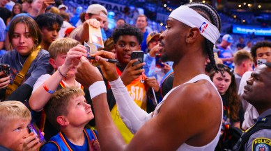 Oklahoma City Thunder guard Shai Gilgeous-Alexander signs autographs prior to Game 1 vs. Minnesota Timberwolves in a NBA basketball Western Conference Finals playoff series Tuesday, May 20, 2025, in Oklahoma City. (AP Photo)