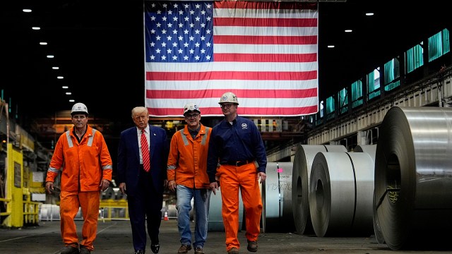 US President Donald Trump walks with workers as he tours US Steel Corporation's Mon Valley Works-Irvin plant on Friday