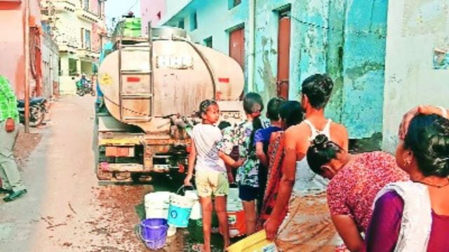 Residents of Kaimbwala village queue up with buckets and containers to collect water from a tanker , water crisis (Express Photo)