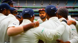 Former India captain Virat Kohli, center, addresses India teammates as they prepare to take to the field during the third Test in Melbourne. (AP Photo)