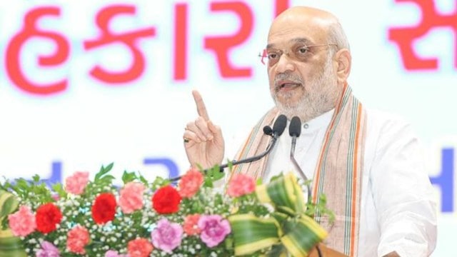Union Home Minister Amit Shah addresses the gathering during 'Cooperative Mega Conference' organized by Gujarat State Co-operative Union, in Ahmedabad on Sunday. (ANI Photo)