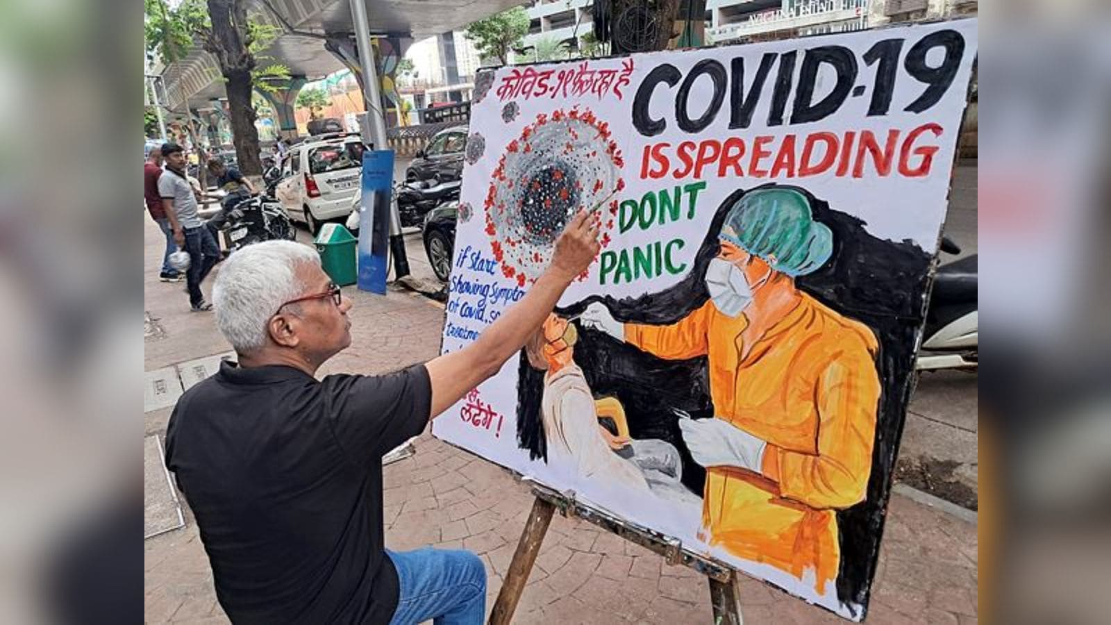 A teacher of Gurukul School of Art makes an awareness painting of COVID 19, in Mumbai on Wednesday. (ANI Photo)