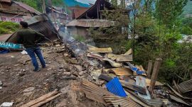 A man stands near damaged houses after shelling by Pakistani troops, in Gingle area of Uri in Baramulla district, Friday. (PTI Photo)