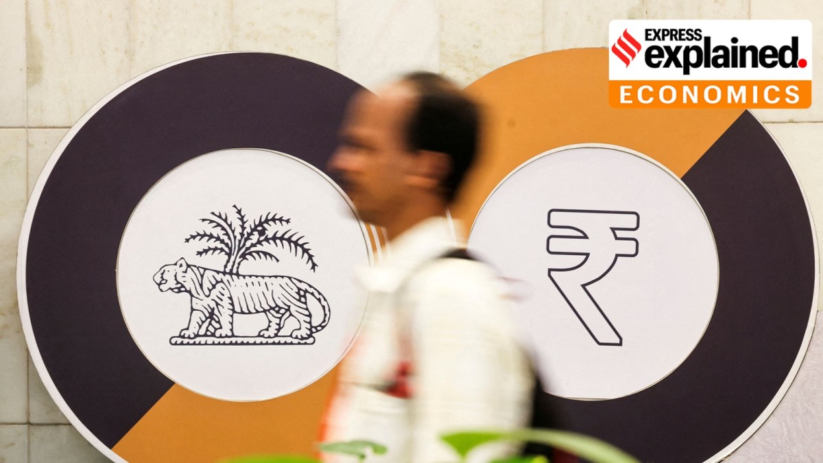 A man walks past a logo of the Reserve Bank of India (RBI) and the Indian Rupee inside the RBI headquarters in Mumbai, India, December 6, 2024.