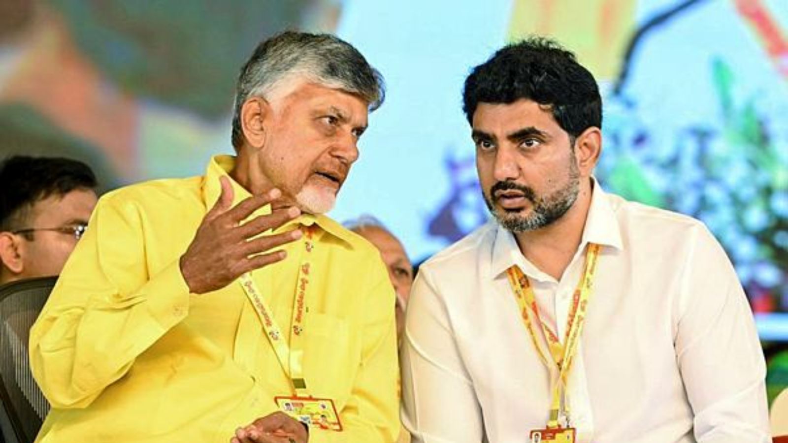 Kadapa, [Andhra Pradesh], 27 May (ANI): Andhra Pradesh Chief Minister N Chandrababu Naidu and state Minister Nara Lokesh in conversation during the Telugu Desam Party's (TDP) annual three-day Mahanadu conclave, in Kadapa on Tuesday. (ANI Photo)