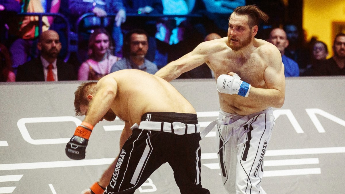 Andrew Batey, a venture capitalist, delivers a punch to his opponent Chauncey St. John, a crypto entrepreneur, during the first round of their fight in Denver on Feb. 28, 2025.