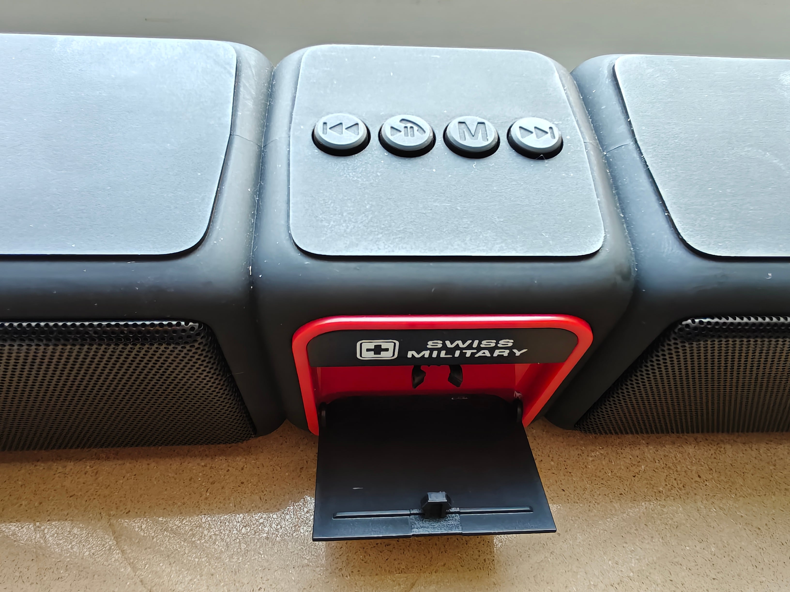 There is a flap up front that can hold your smartphone in place.