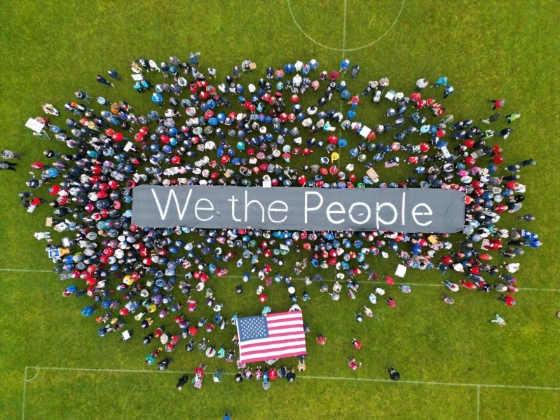 A drone view shows protesters holding a We the People sign in Bennington County, Vermont, a town of 37,000 people 