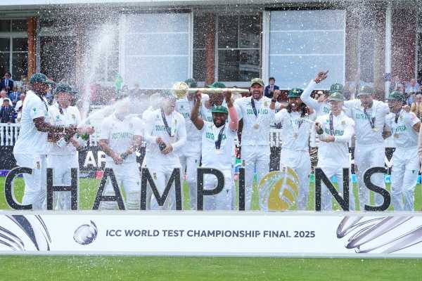 South Africa's captain Temba Bavuma holds the winner's trophy and celebrates with teammates after their win in the World Test Championship final against Australia at Lord's. (AP Photo)